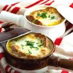 Two crock with French onion soup.