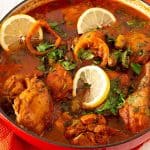 A pot with chicken and veggies.