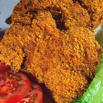 Baked crispy chicken on the serving dish.