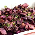 Roast purple potatoes in a baking dish.