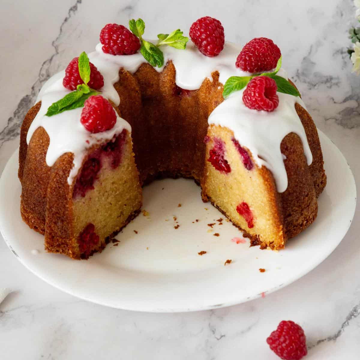 A sliced raspberry cake with lemons.