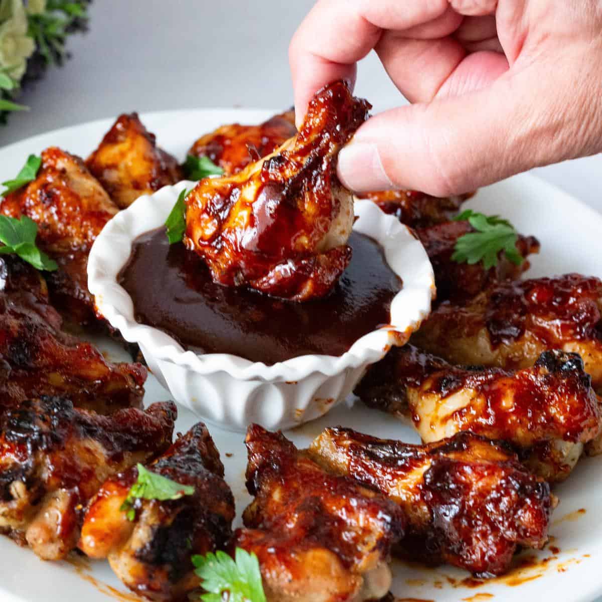 A plate with BBQ chicken wings.