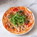 A plate with salmon carpaccio.