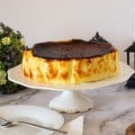 A whole basque burnt cheesecake on the cake stand.