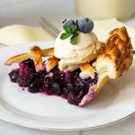 Homemade Blueberry Pie slice with ice cream.