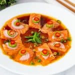 A plate with salmon in ponju sauce.