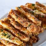 A stack of garlic parmesan pastry sticks.