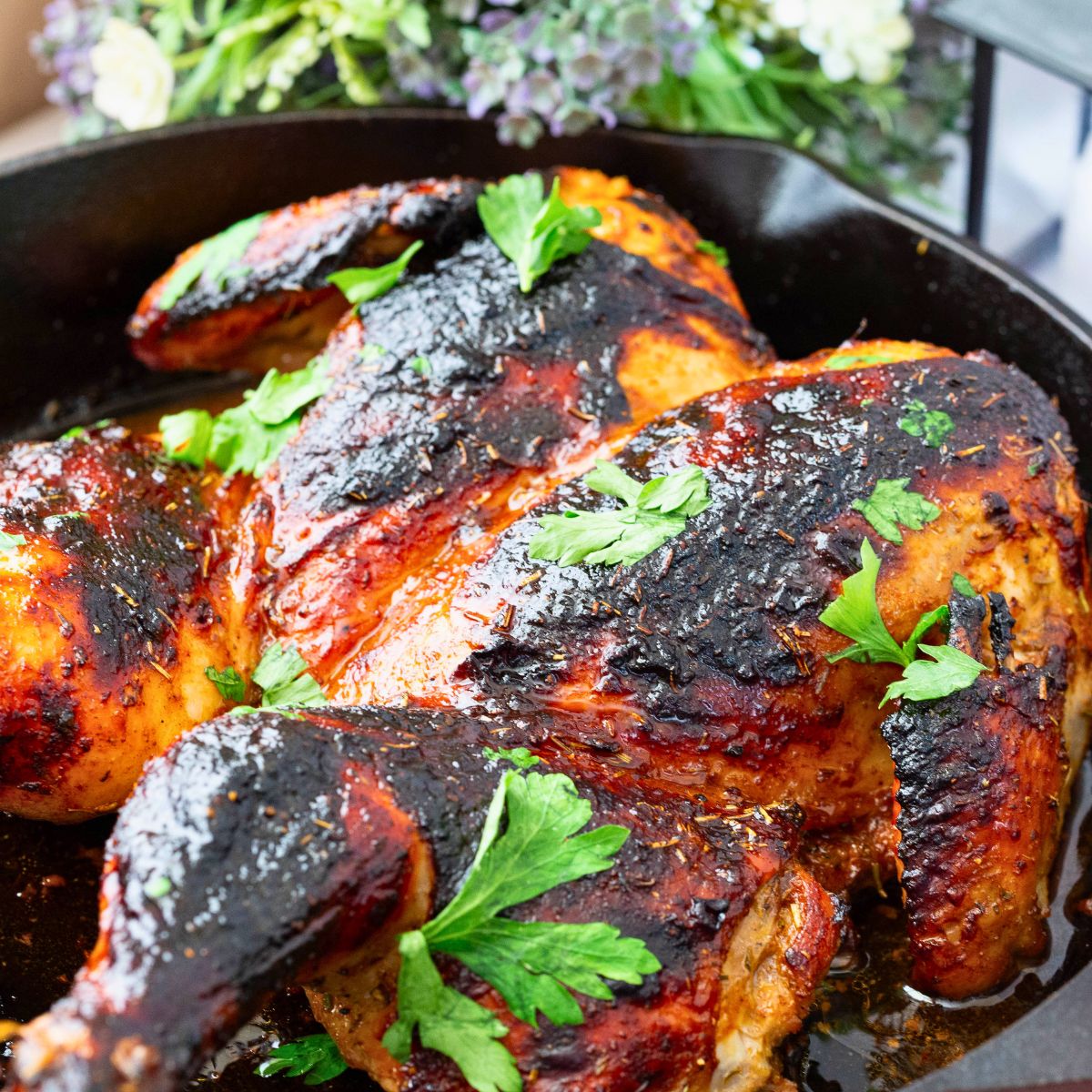 A cast iron pan with roasting chicken.
