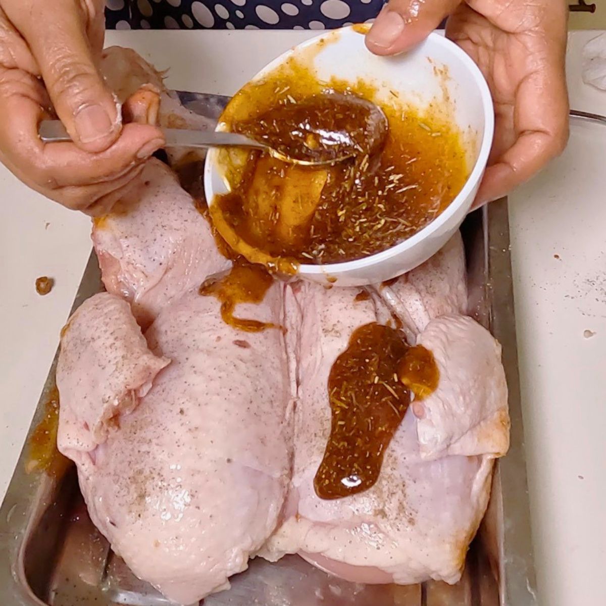 Marinating the chicken for roasting.