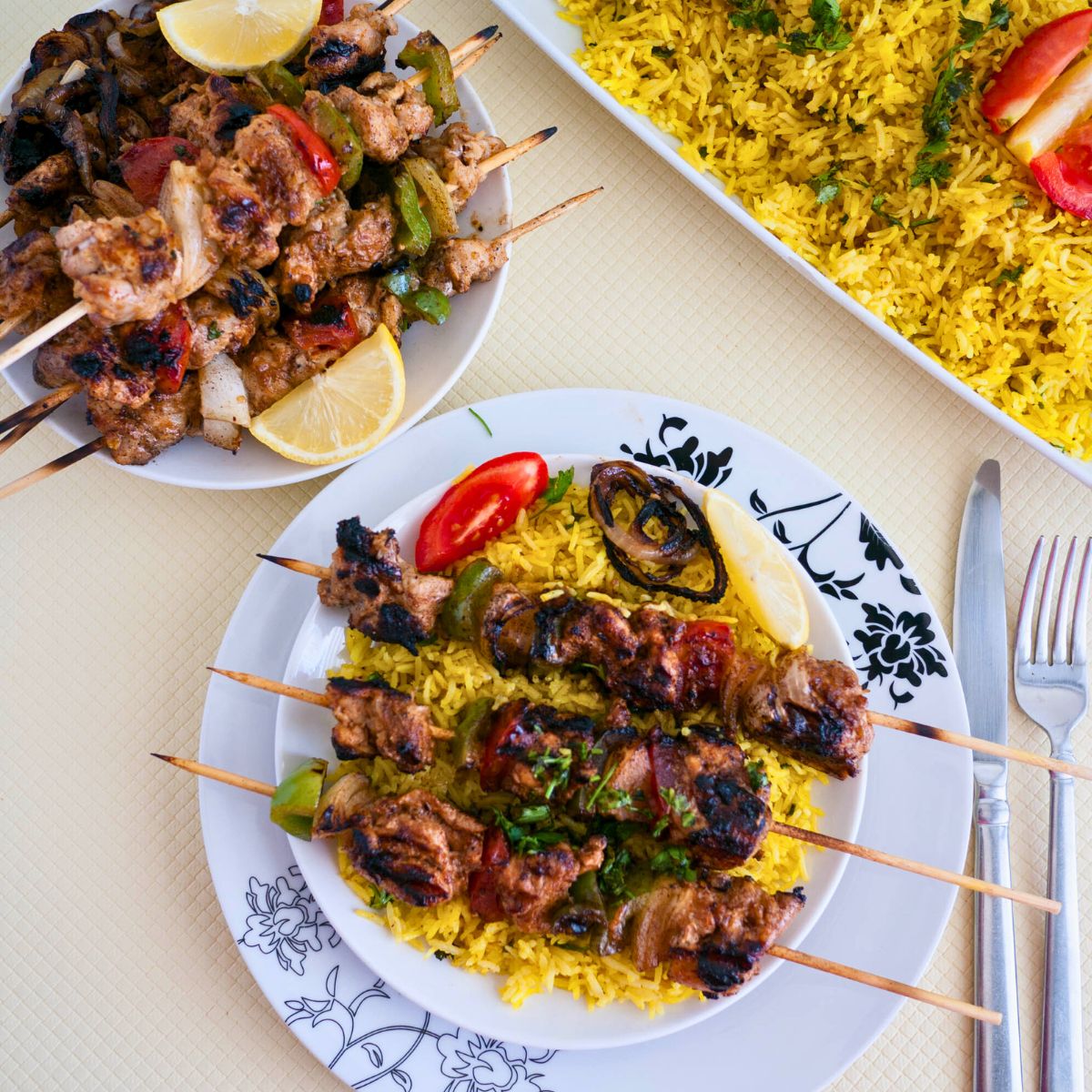 A table set up for rice, kebabs, and pita bread.