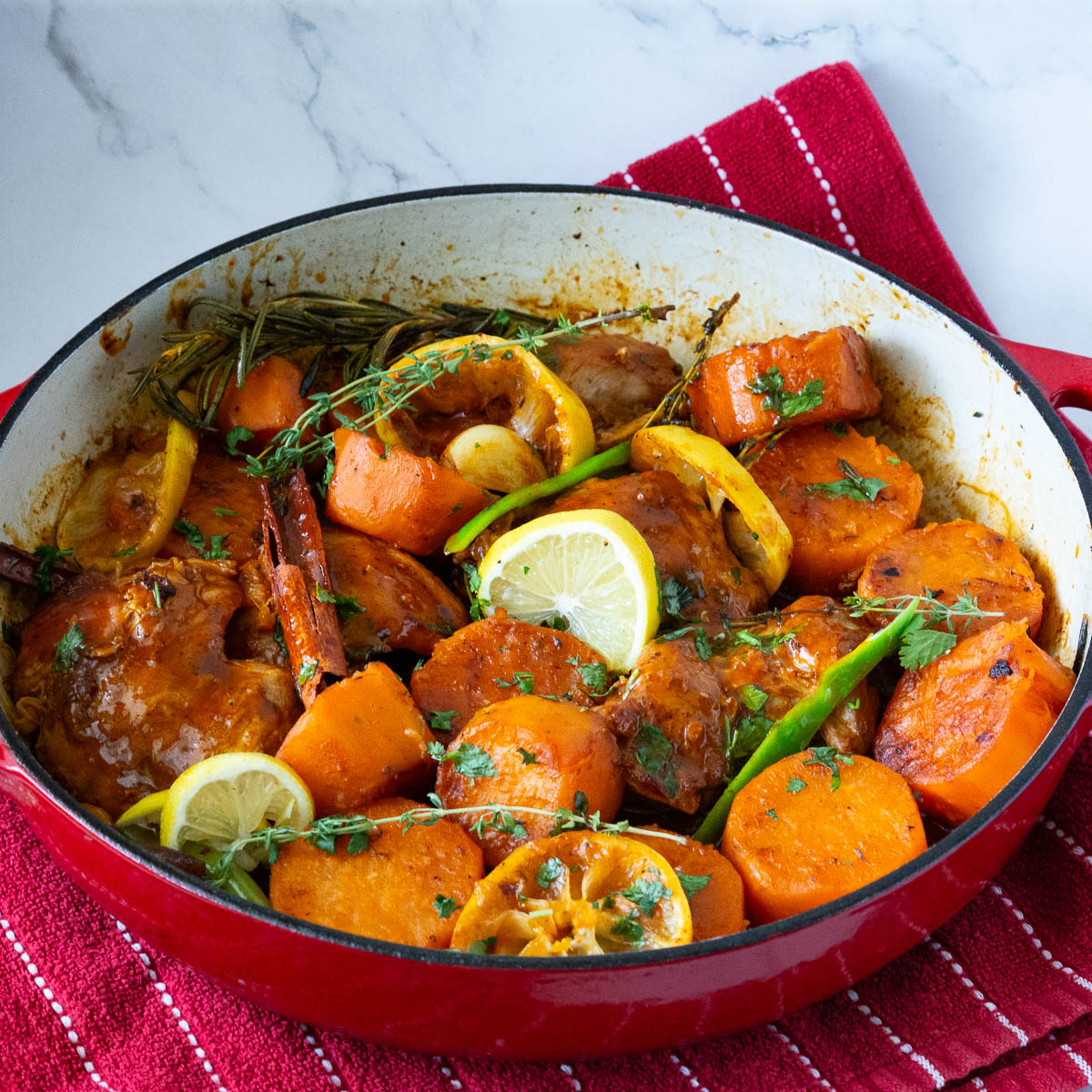 A Dutch oven pan with braised chicken.