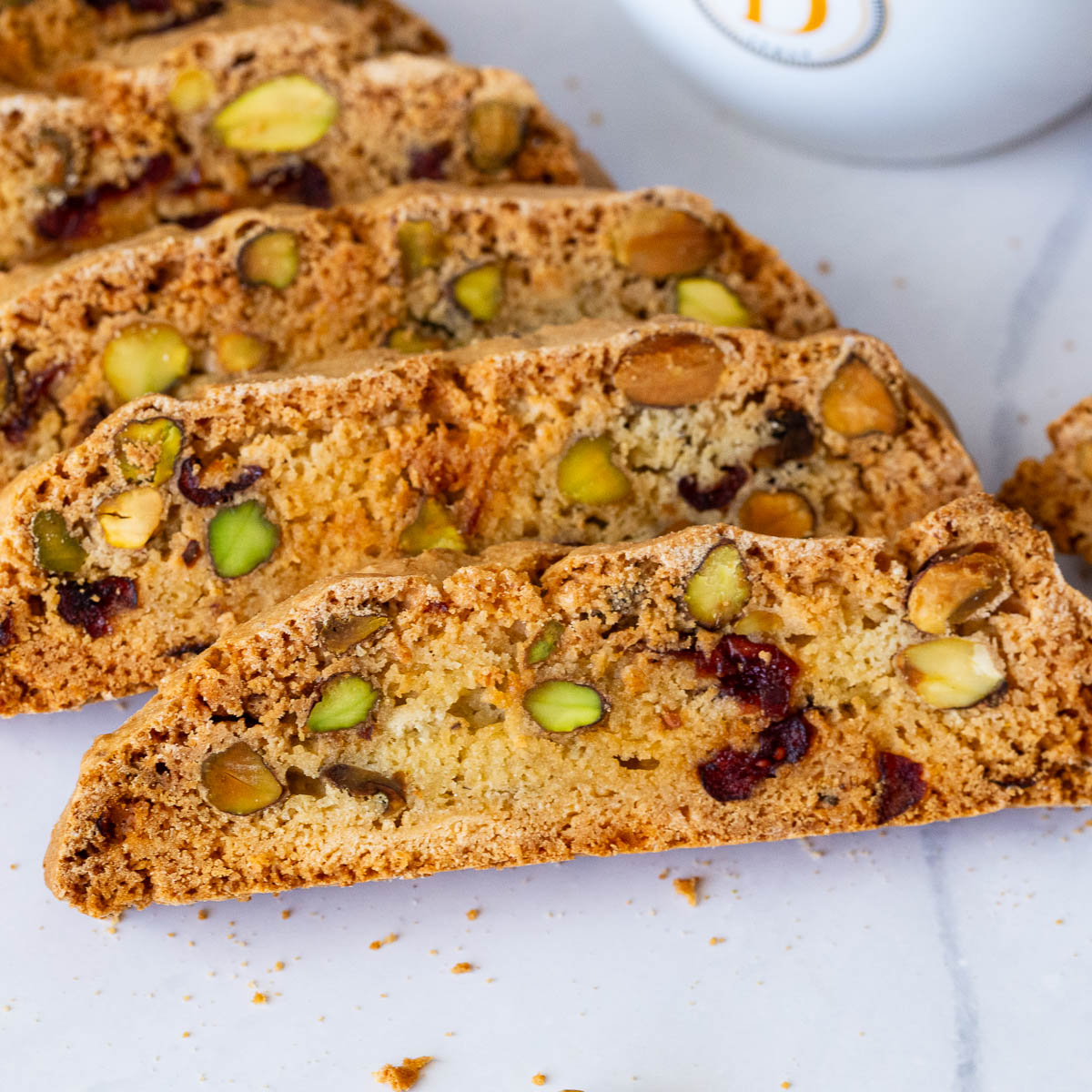 Slices of biscotti on a baking tray.