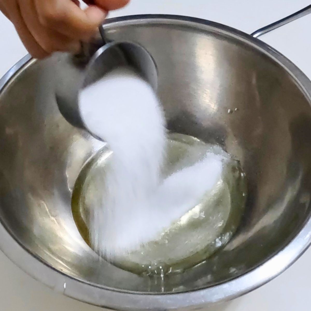 Whipping egg whites with sugar for macaroons.