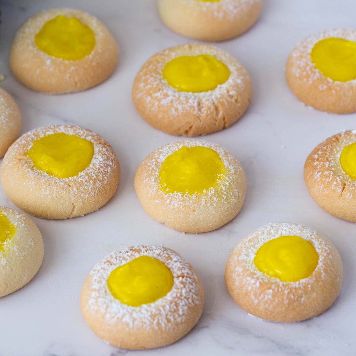 Thumbprint cookies with lemon curd filling on the table.