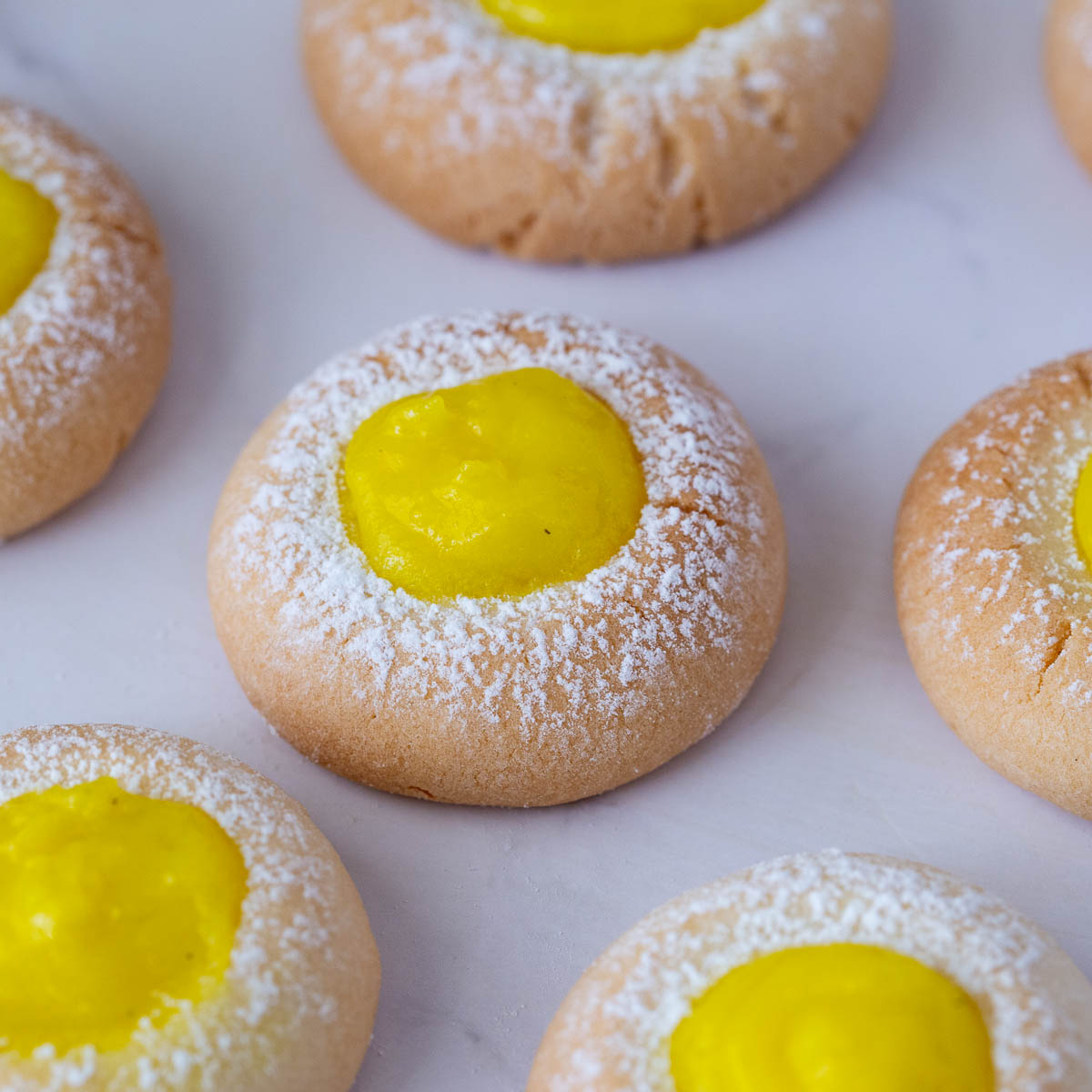 Thumbprint cookies with lemon curd filling on the table.