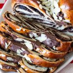 A sliced chocolate challah on the table.
