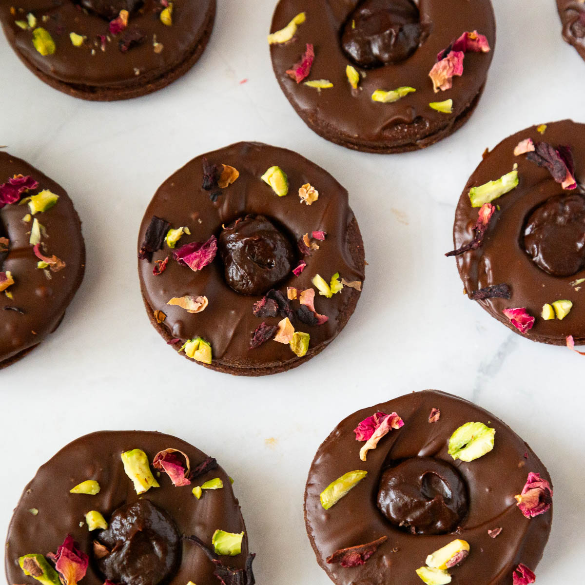 Linzer cookies with chocolate ganache on the table.