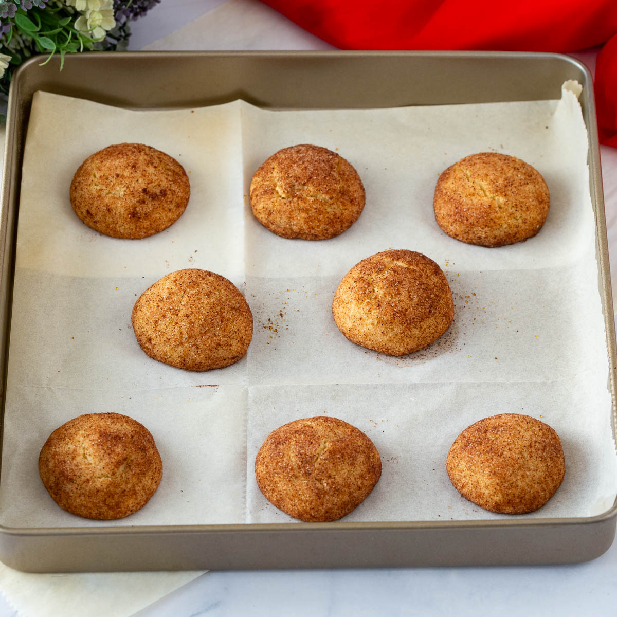 A baking tray with cinnamon sugar cookies.