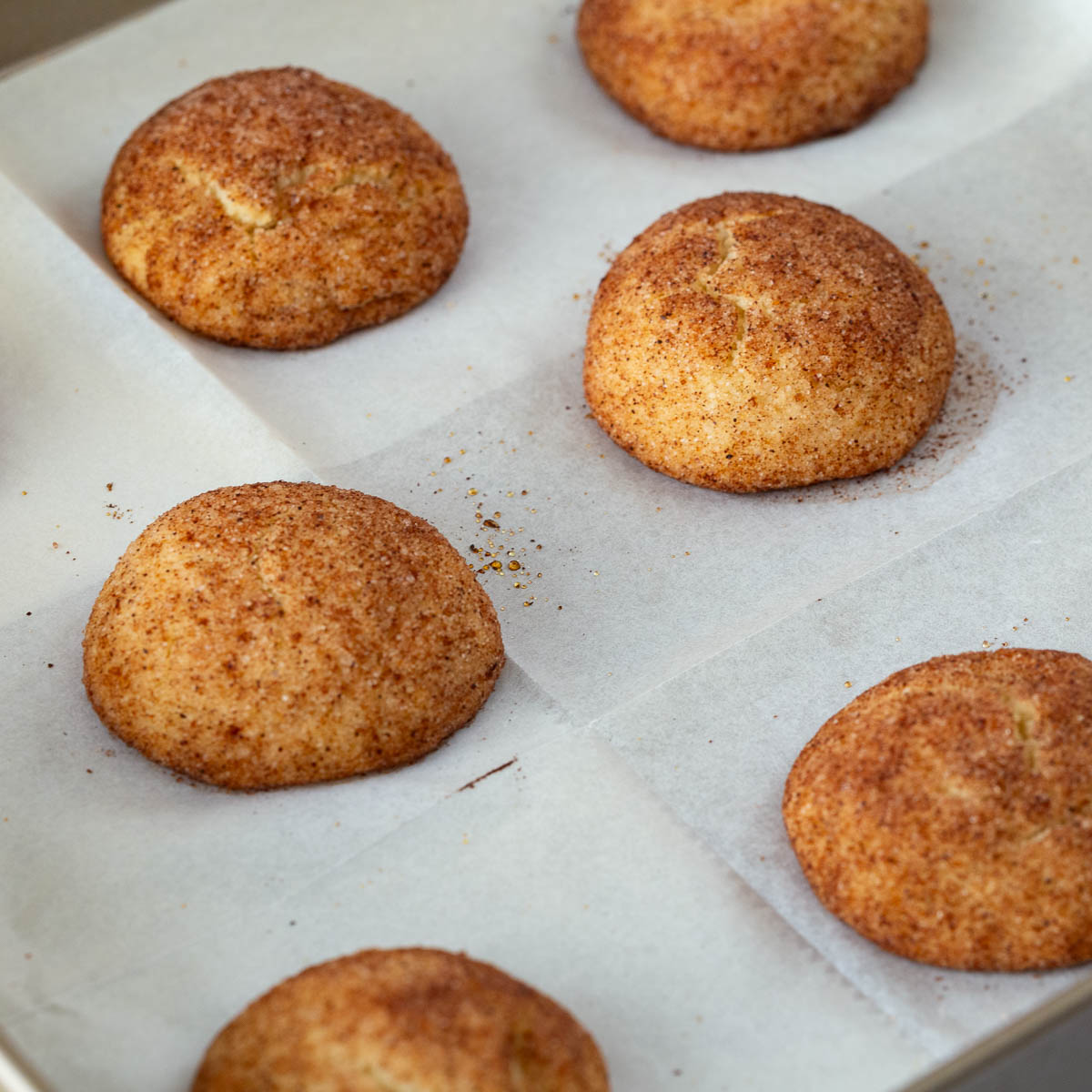 A baking tray with cinnamon sugar cookies.