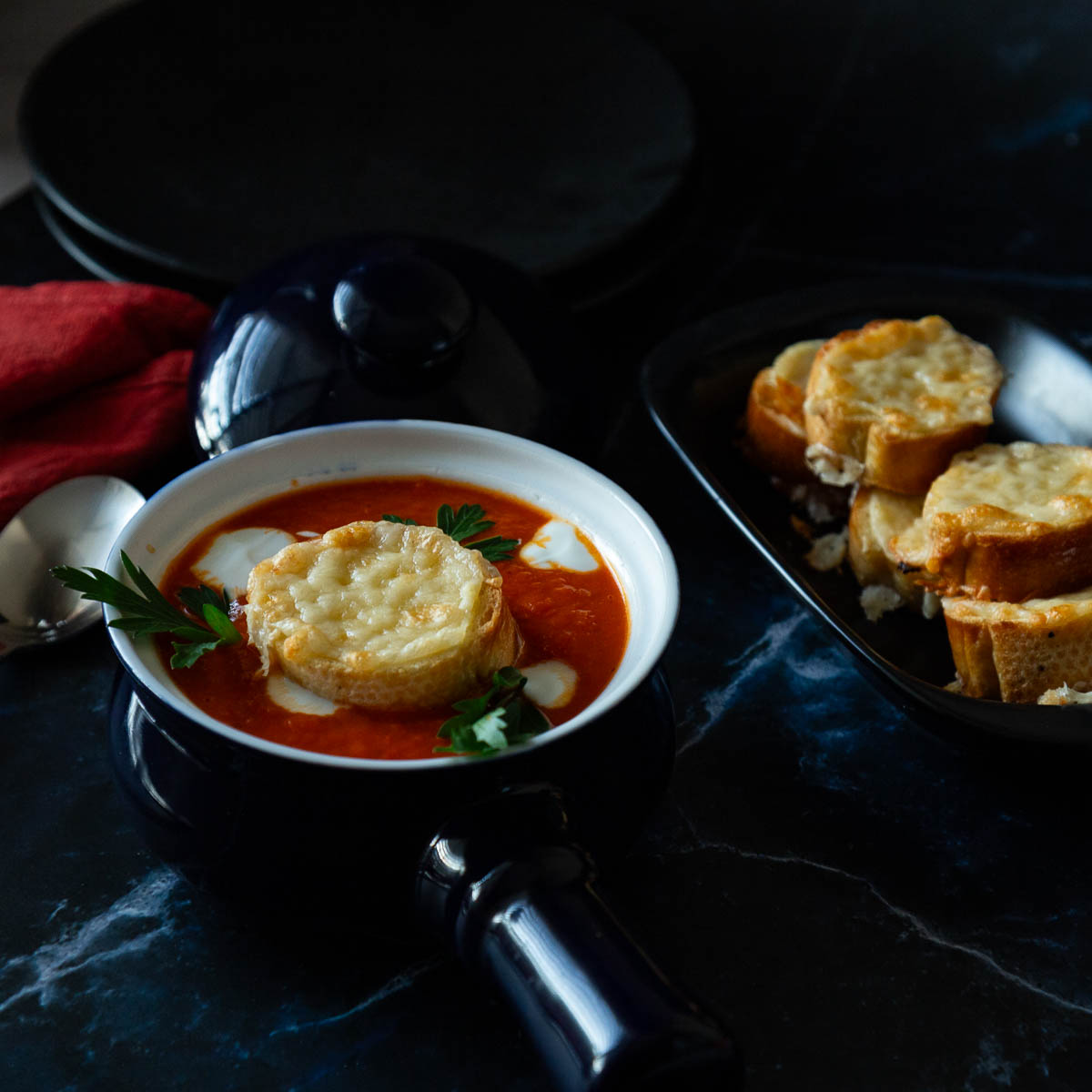 Red soup in a blue bowl.
