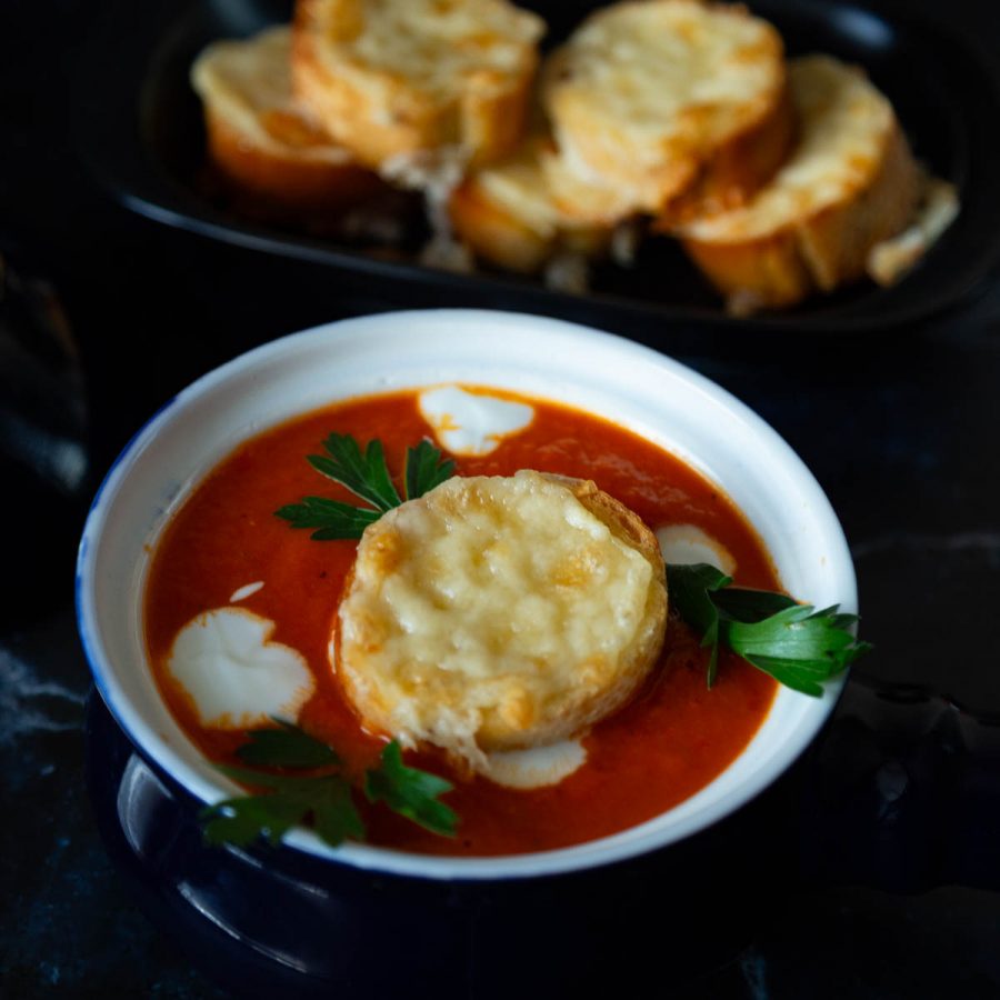 A soup bowl with red soup.