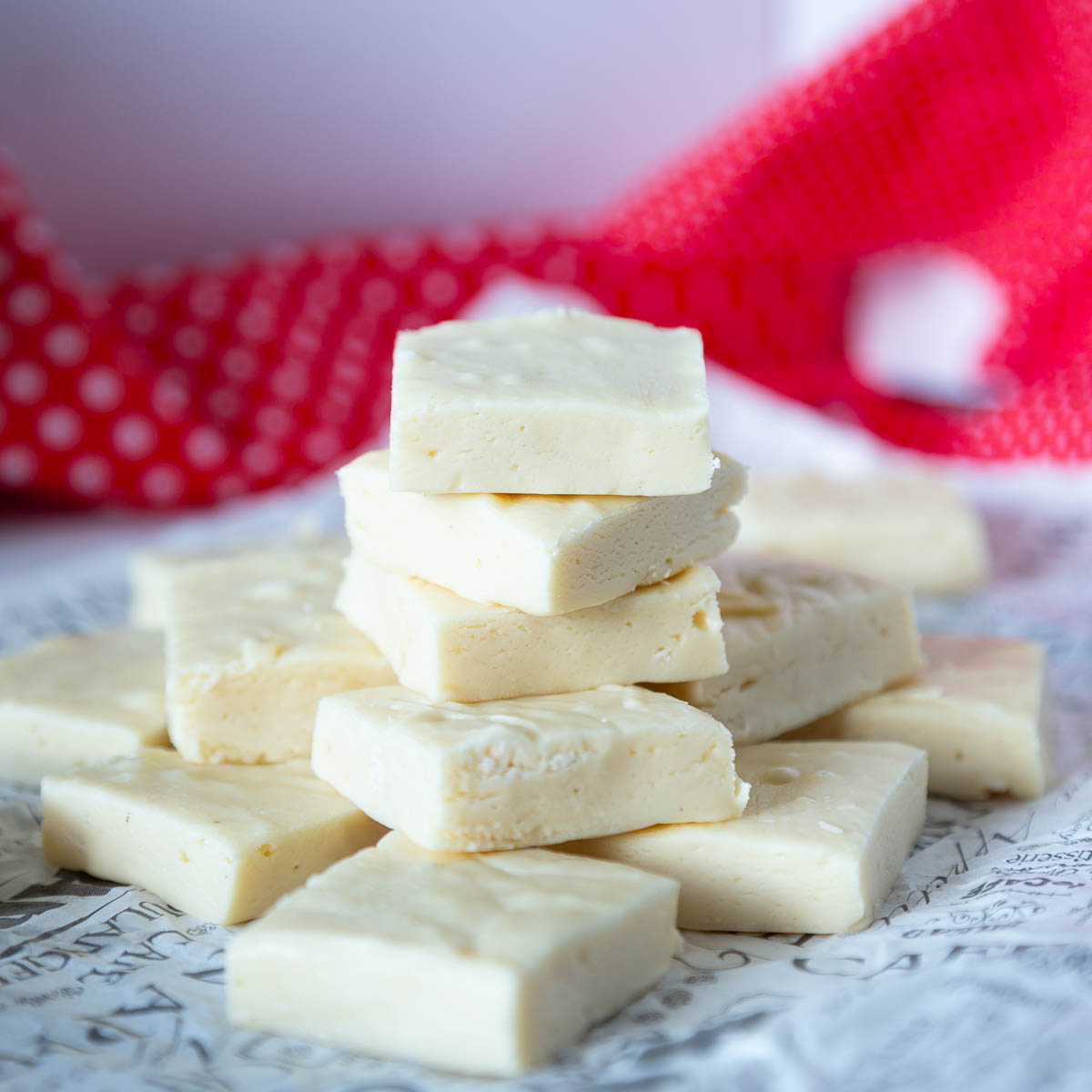 A stack of white chocolate fudge on the table.