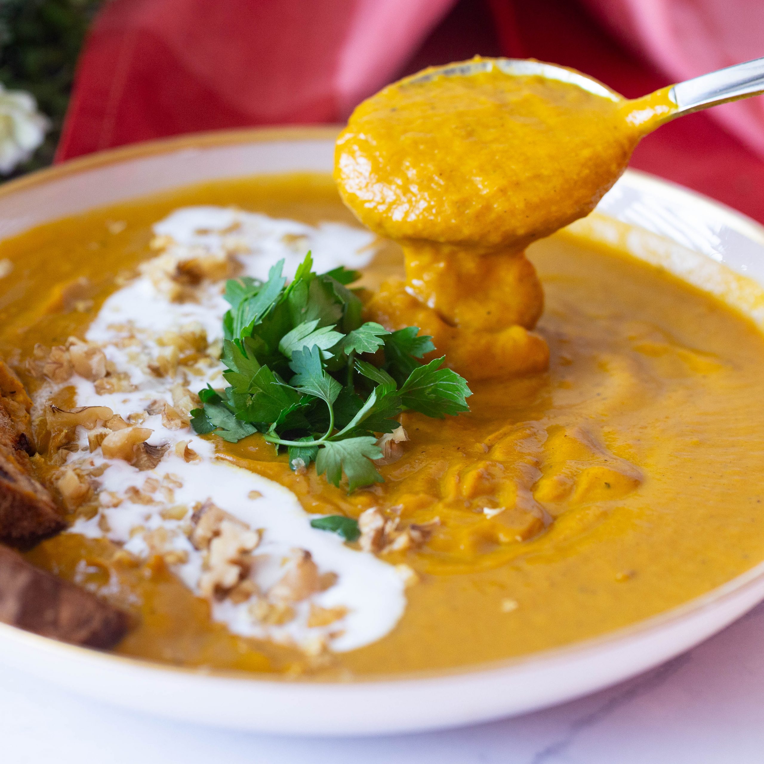 A bowl and soup with roast carrots and ginger.