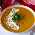 A bowl with roast carrot soup.