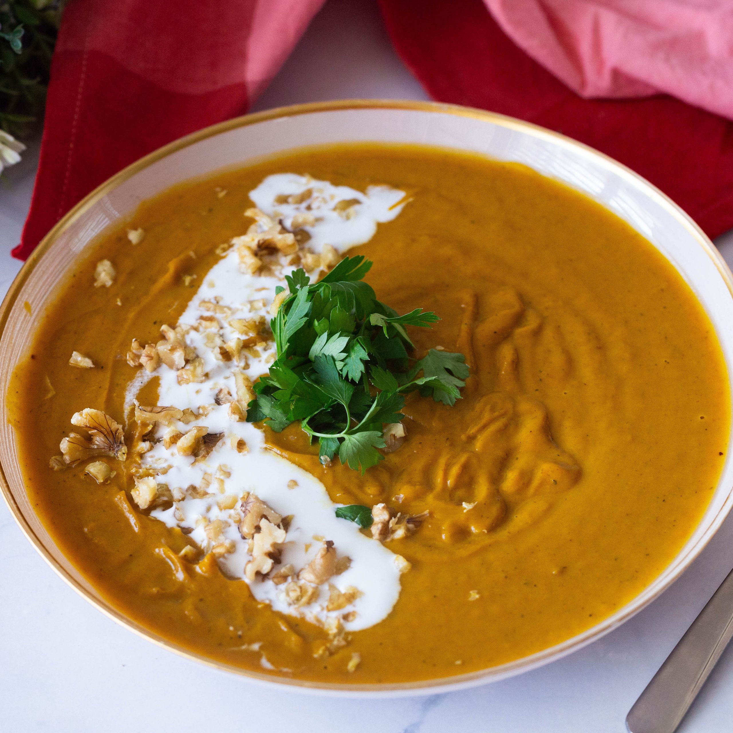 A bowl with roast carrot soup.