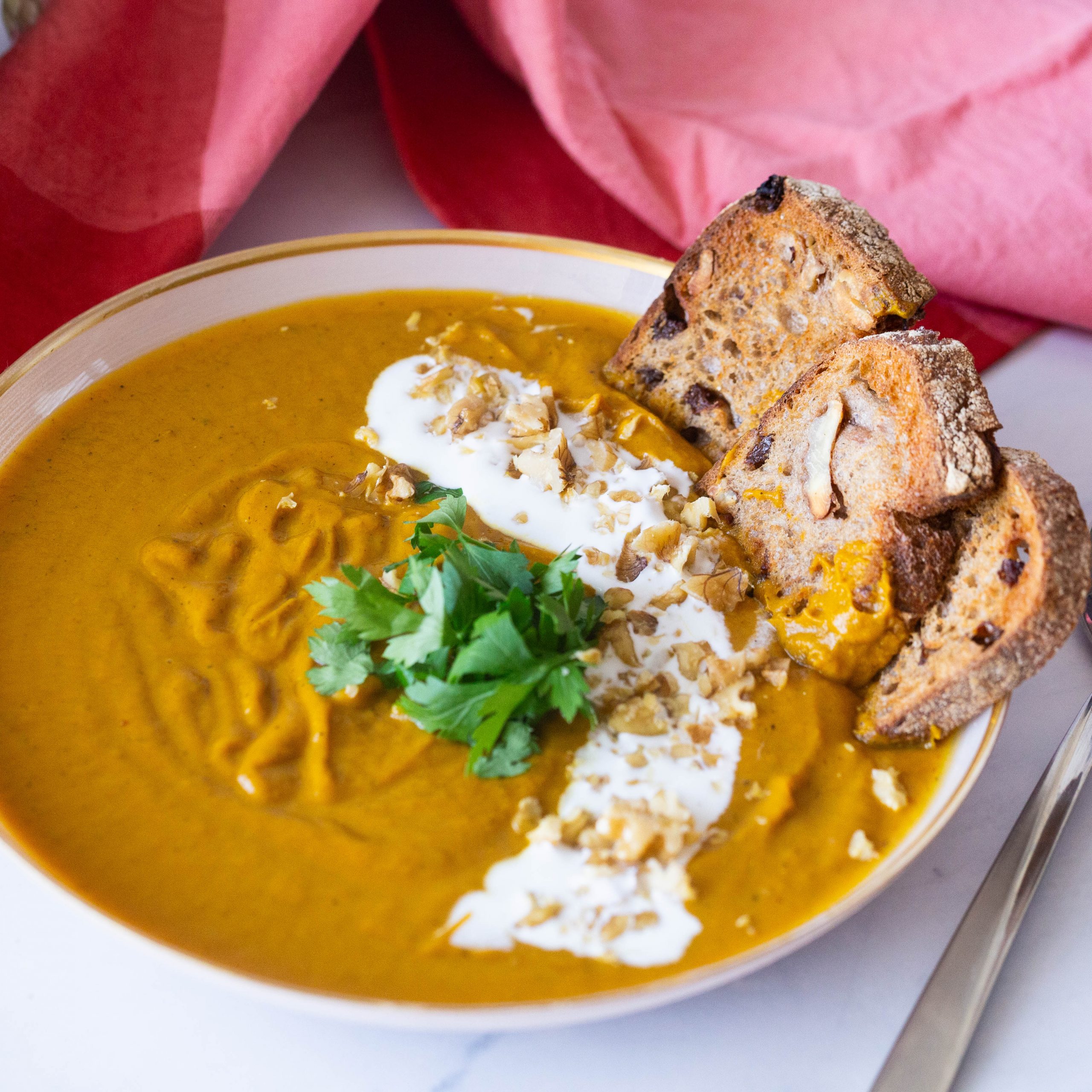 A bowl with soup of roasted carrots.