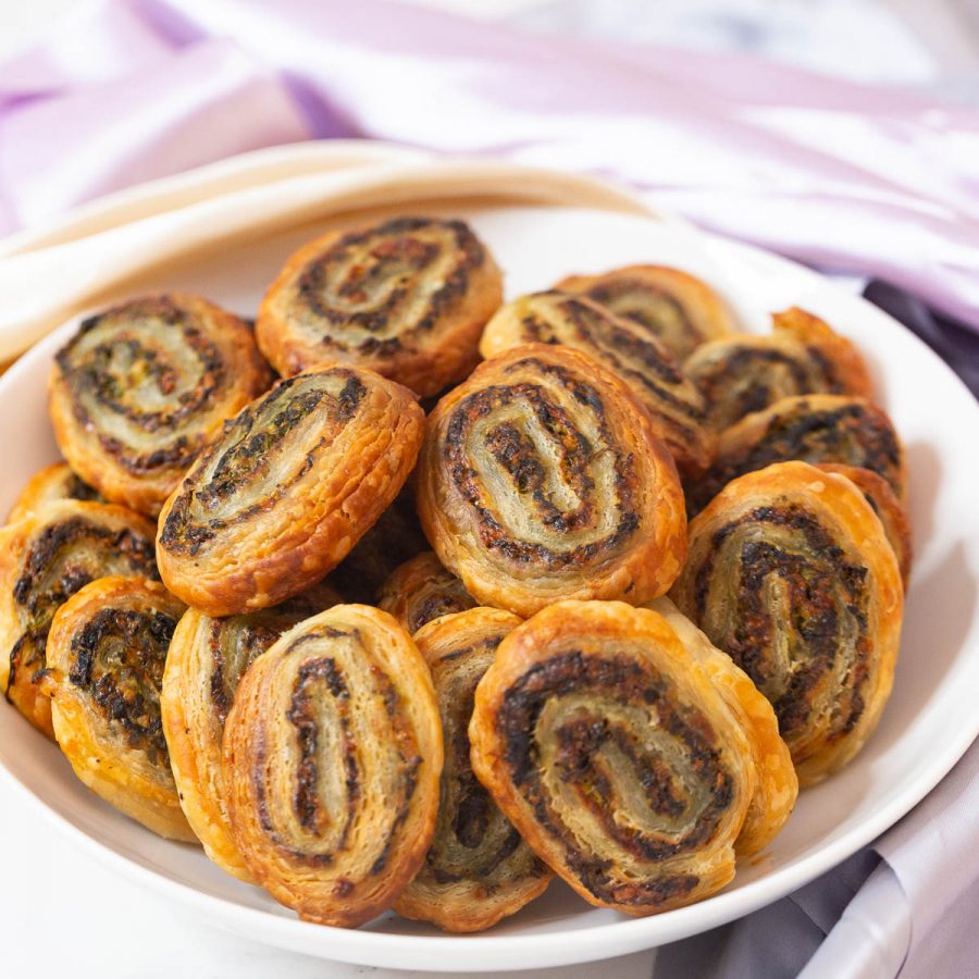A bowl with puff pastry pinwheels.