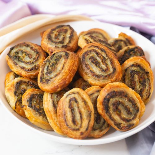 Puff pastry pinwheels appetizers in a bowl.