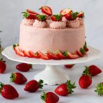 A frosted strawberry cake with cream cheese frosting,