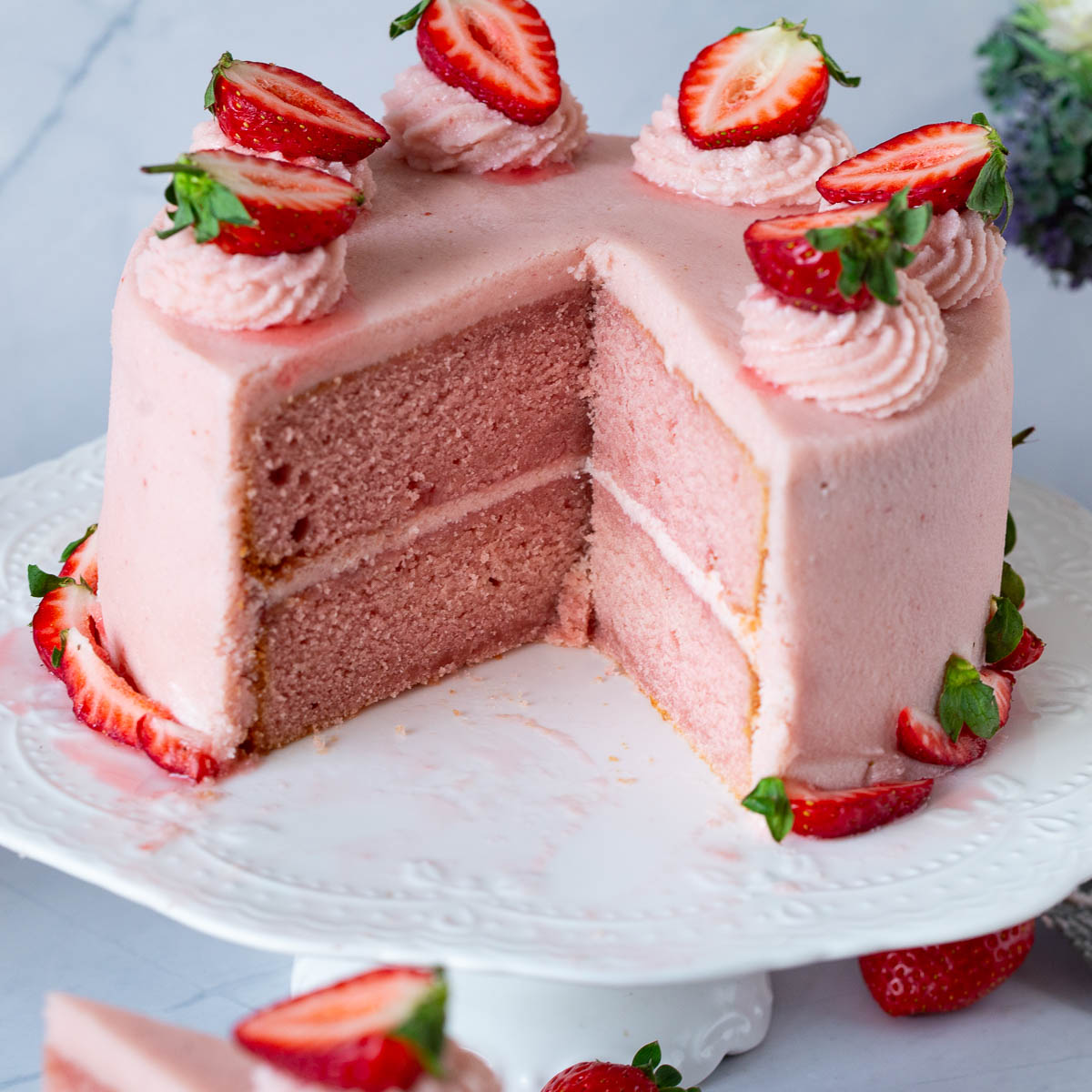 A sliced strawberry cake on the table,