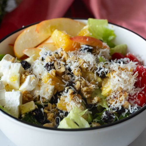 A white bowl with salad.