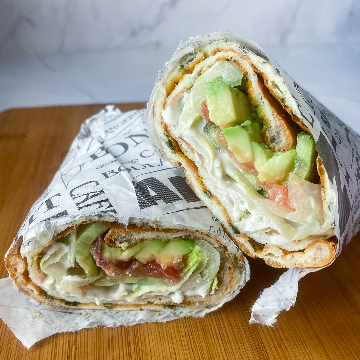 Sandwich wrap on a wooden board.