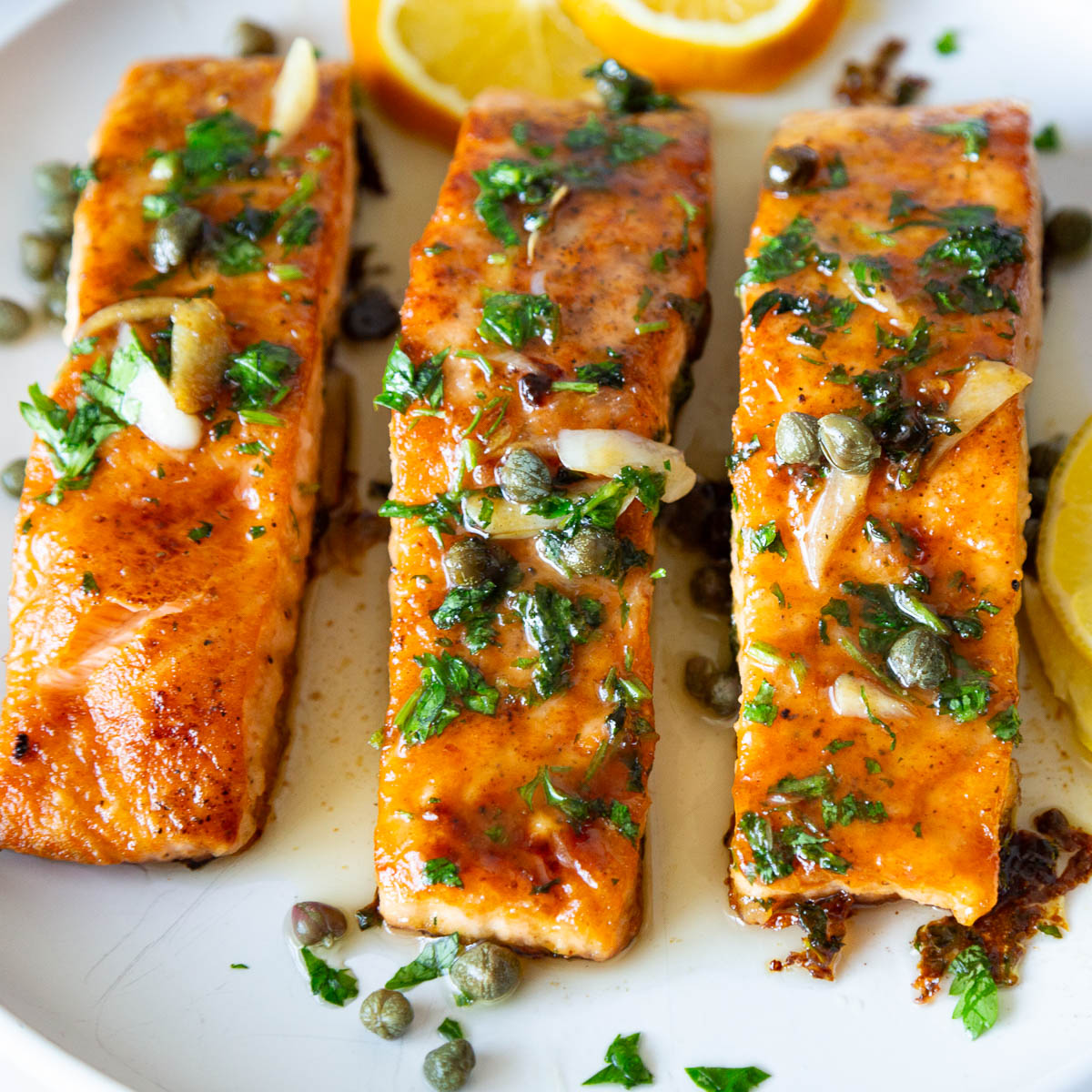 Pan fried salmon fillets on a platter.