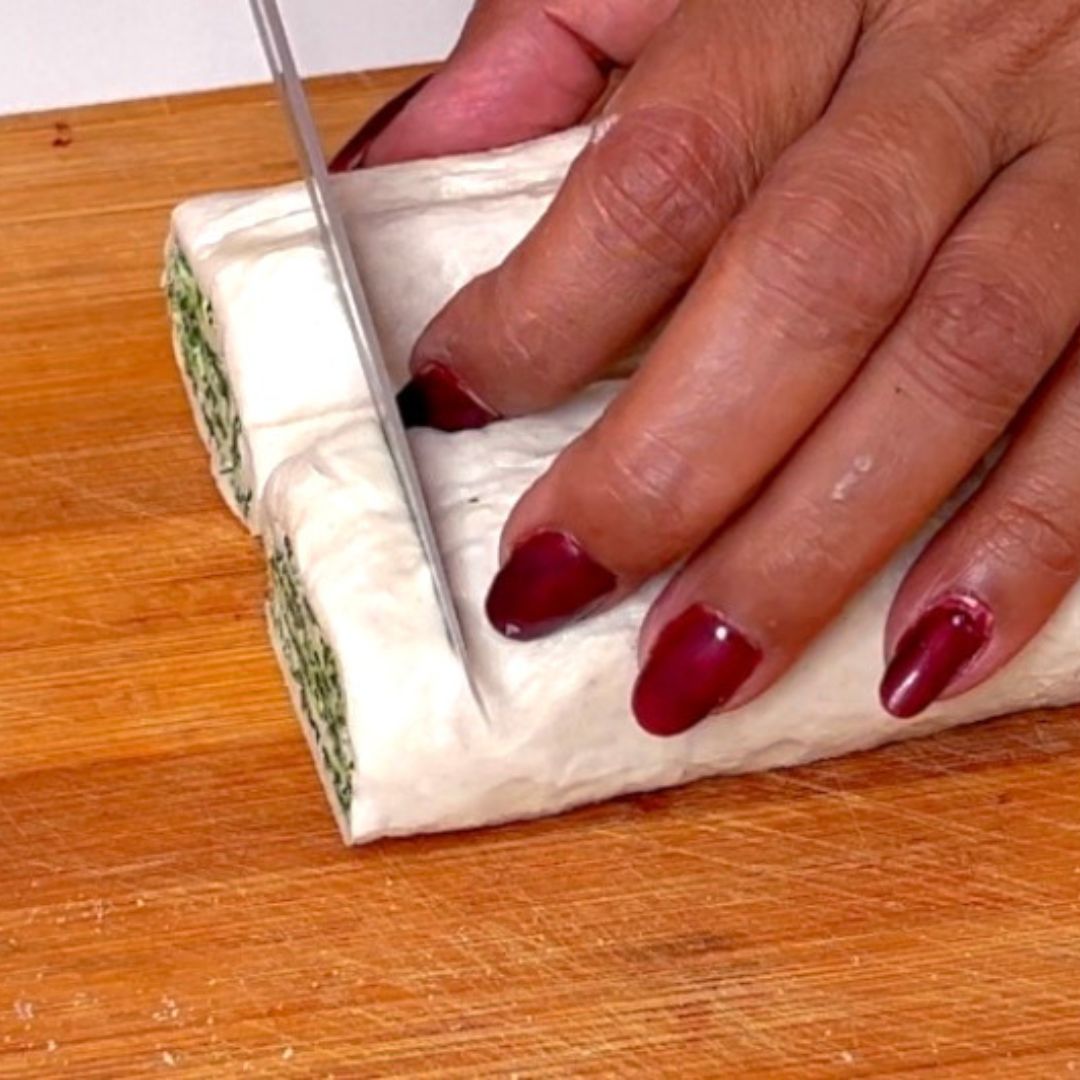 A wooden cutting board with puff pastry.
