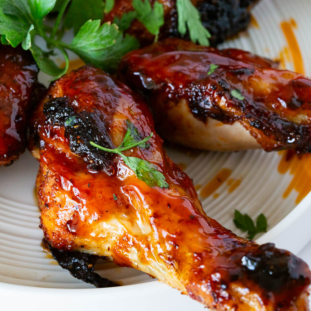 Chicken legs on the white plate.