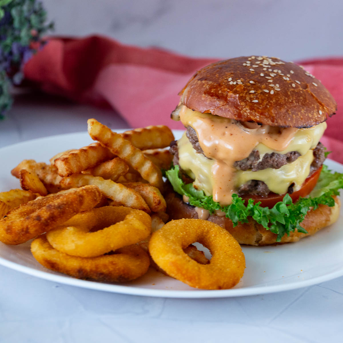 A plate with homemade burger and sauce.