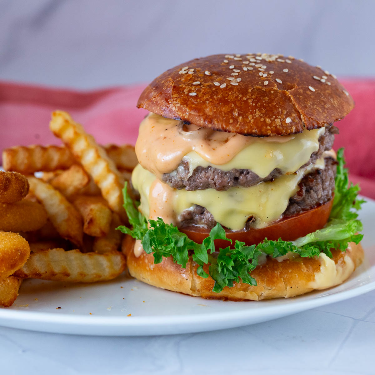 A plate with homemade burger and fries.