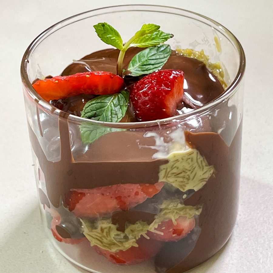 A glass cup with dubai chocolate dessert.