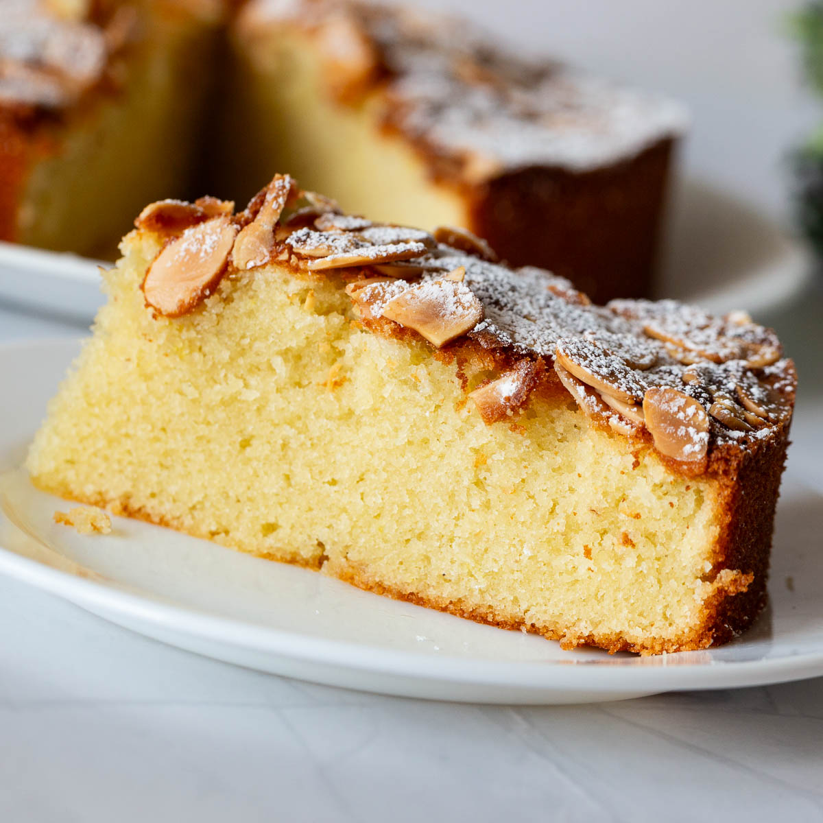 A plate with a slice of almond cake.