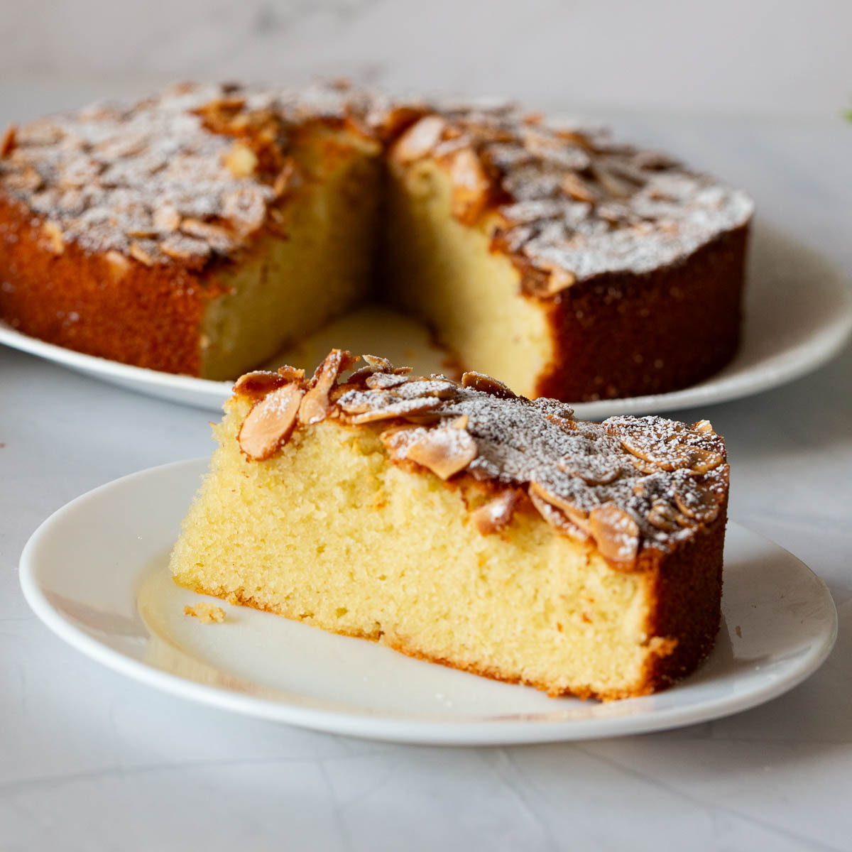 A sliced almond cake on the plate.