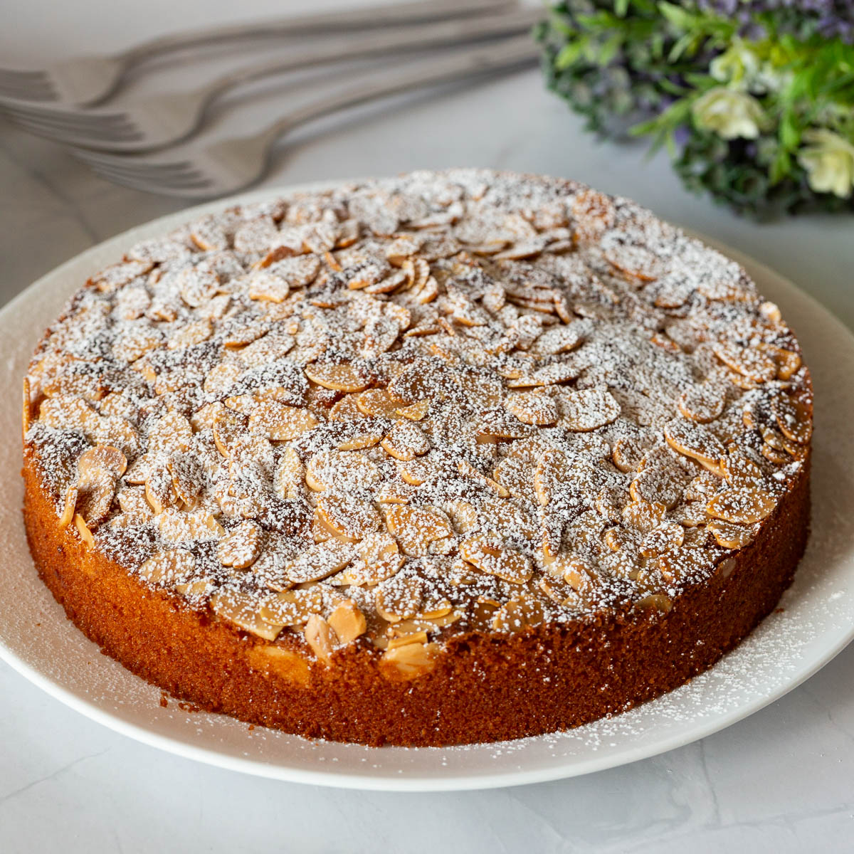 A plate with cake dusted with powdered sugar.