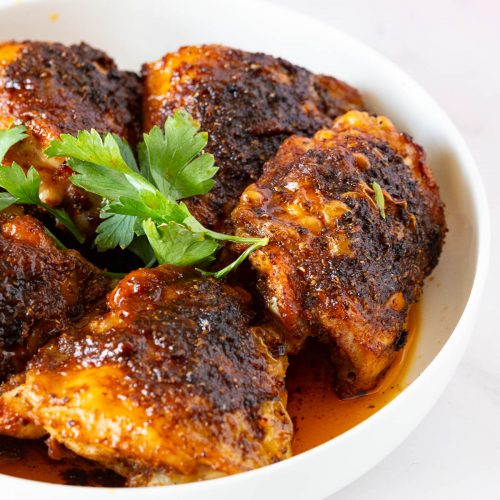 A plate with spicy chicken thighs.