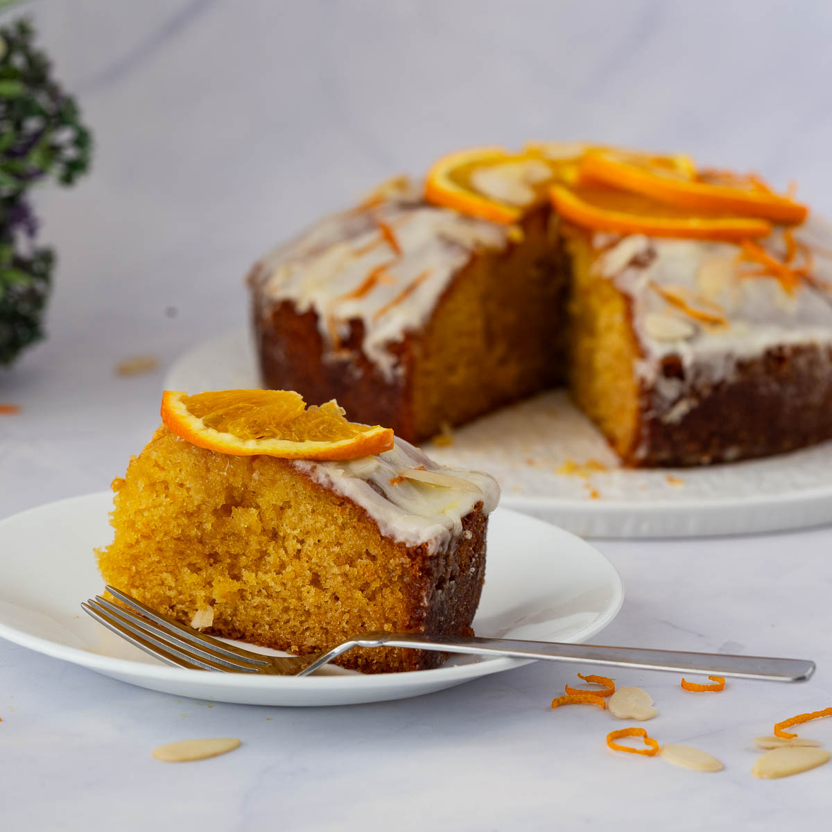A sliced orange cake on the table.