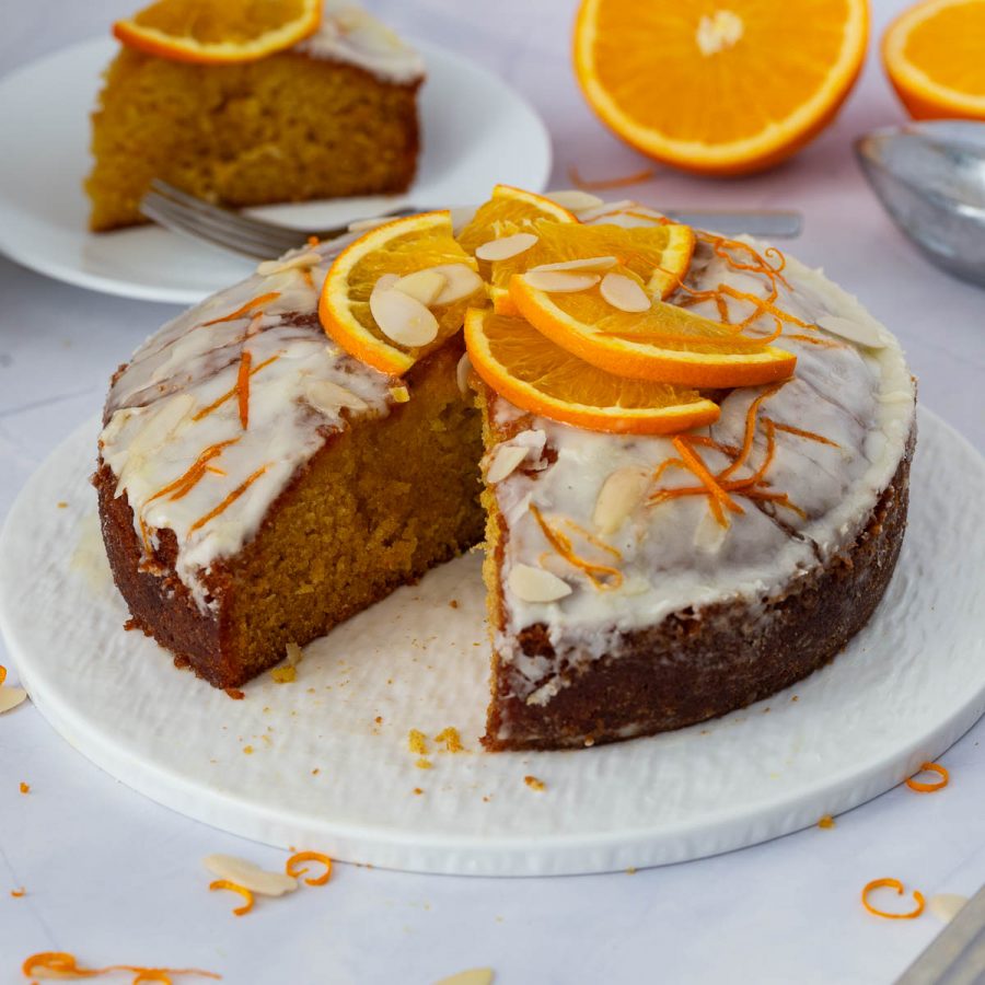 A sliced orange cake on the table.