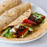 Chicken fajitas on the plate.