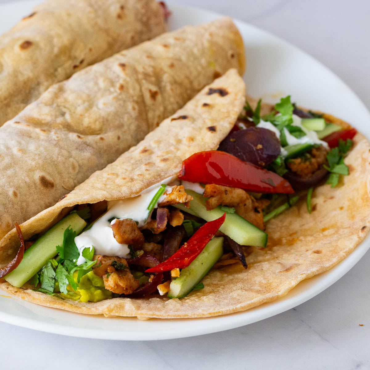 Chicken fajitas on the plate.